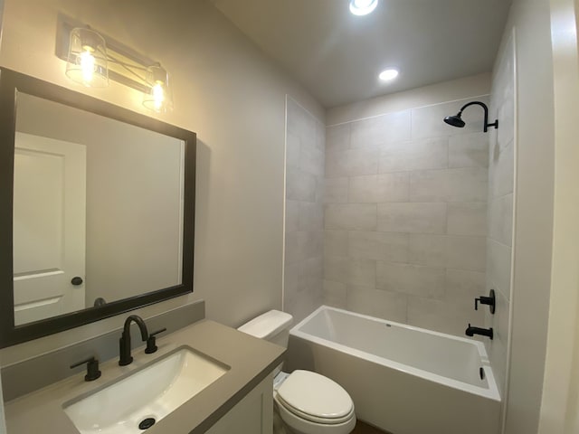 full bathroom featuring vanity, toilet, and tiled shower / bath