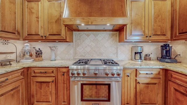 10309 Bussey Rd, Silsbee, TX 77656 - kitchen featuring high end range, custom range hood, tasteful backsplash, and brown cabinetry