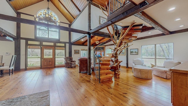 10309 Bussey Rd, Silsbee, TX 77656 - living room with stairway, a chandelier, plenty of natural light, light wood-style floors, and beamed ceiling