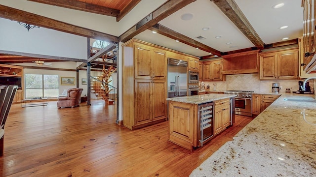10309 Bussey Rd, Silsbee, TX 77656 - kitchen featuring built in appliances, beverage cooler, a sink, beamed ceiling, and light stone counters