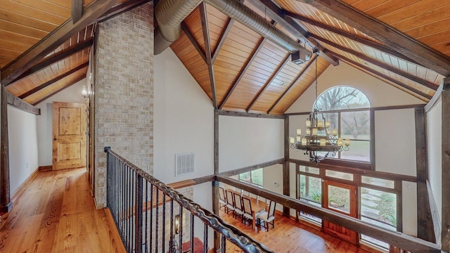 10309 Bussey Rd, Silsbee, TX 77656 - hall with wood ceiling with exposed beams, hardwood / wood-style flooring, a chandelier, high vaulted ceiling, and an upstairs landing