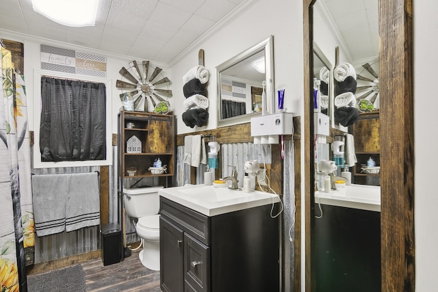 bathroom featuring vanity, hardwood / wood-style flooring, toilet, and crown molding