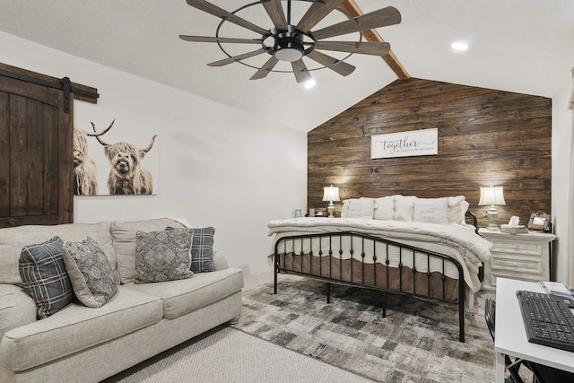 bedroom featuring lofted ceiling with beams, wooden walls, ceiling fan, a barn door, and carpet floors