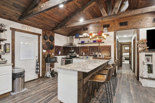 kitchen with a kitchen breakfast bar, dark hardwood / wood-style flooring, wood ceiling, wall chimney range hood, and stainless steel range with electric cooktop