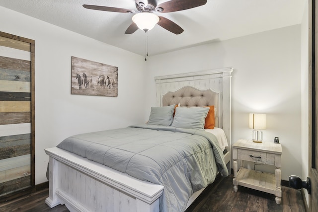 bedroom with dark hardwood / wood-style floors and ceiling fan