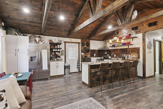 kitchen featuring wooden ceiling, ventilation hood, stainless steel refrigerator with ice dispenser, beam ceiling, and white cabinetry