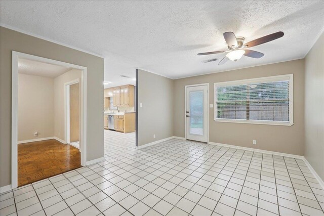 6250 Carnation Dr, Beaumont, TX 77706 - empty room featuring ceiling fan, a textured ceiling, baseboards, and light tile patterned floors