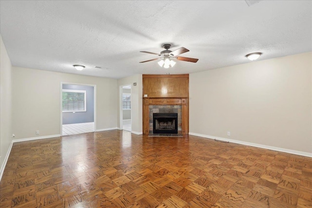 6250 Carnation Dr, Beaumont, TX 77706 - unfurnished living room with baseboards, a textured ceiling, ceiling fan, and a fireplace