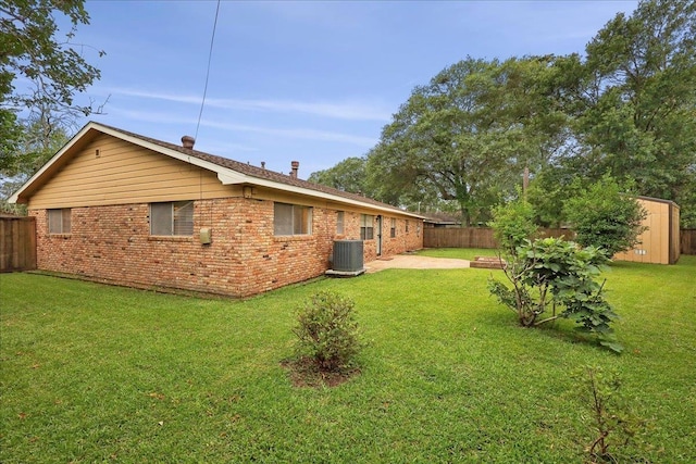 6250 Carnation Dr, Beaumont, TX 77706 - back of house featuring brick siding, a patio area, and central AC