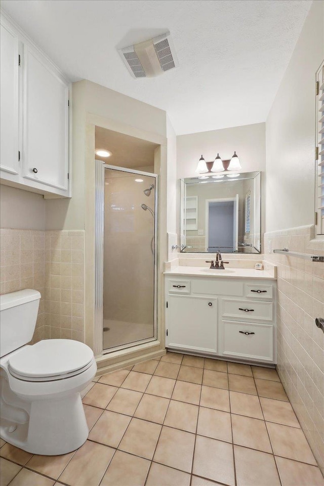 6250 Carnation Dr, Beaumont, TX 77706 - full bath featuring tile walls, vanity, tile patterned flooring, a stall shower, and toilet