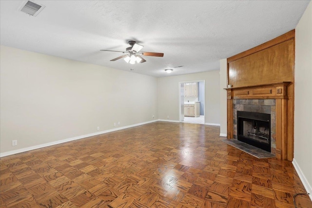 6250 Carnation Dr, Beaumont, TX 77706 - unfurnished living room with a ceiling fan, baseboards, a fireplace, and a textured ceiling