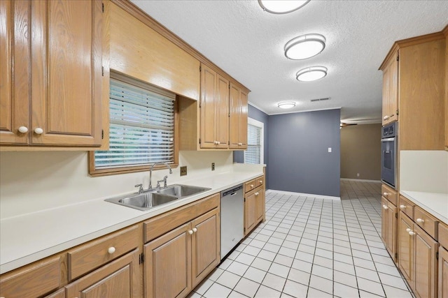6250 Carnation Dr, Beaumont, TX 77706 - kitchen with a sink, stainless steel appliances, light countertops, a textured ceiling, and baseboards