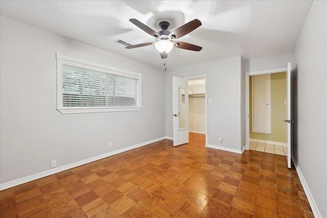6250 Carnation Dr, Beaumont, TX 77706 - unfurnished bedroom with baseboards, a walk in closet, a closet, and a ceiling fan