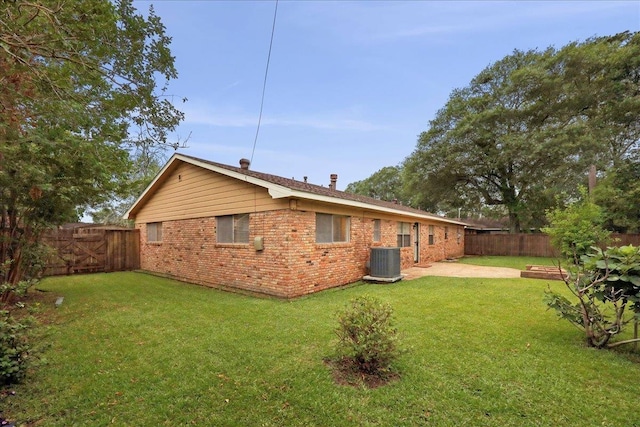 6250 Carnation Dr, Beaumont, TX 77706 - back of property with cooling unit, brick siding, and a patio area
