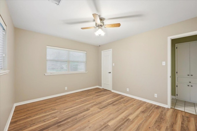6250 Carnation Dr, Beaumont, TX 77706 - unfurnished bedroom featuring light wood-style flooring, baseboards, and a ceiling fan