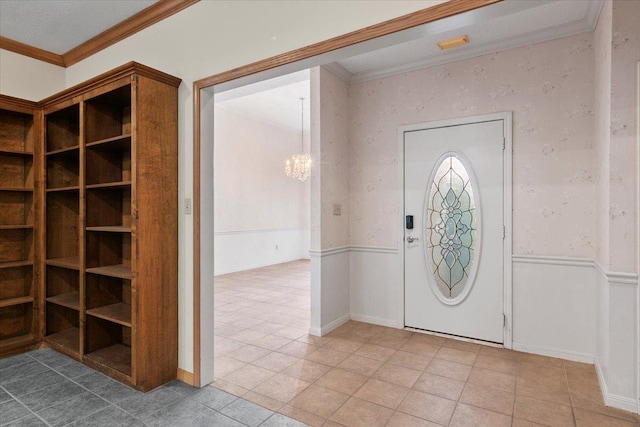 foyer with a notable chandelier and crown molding