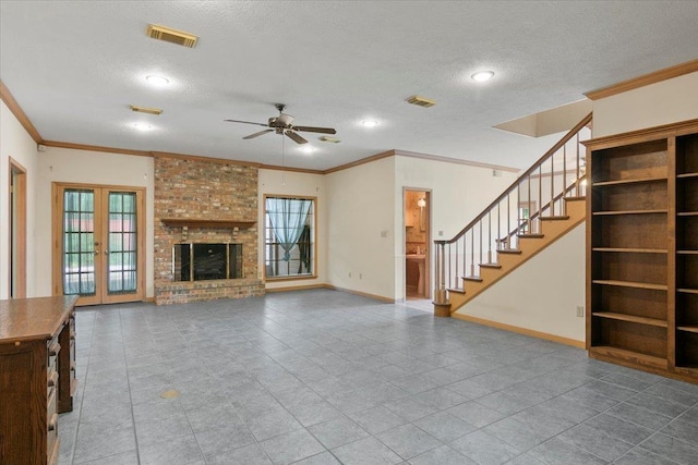 unfurnished living room with ceiling fan, a textured ceiling, a wealth of natural light, and french doors