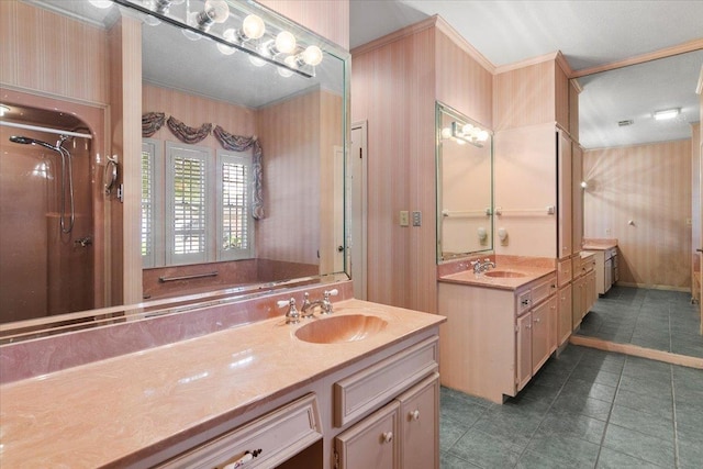 bathroom with vanity, a shower with door, and crown molding