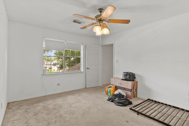 misc room with ceiling fan and light colored carpet