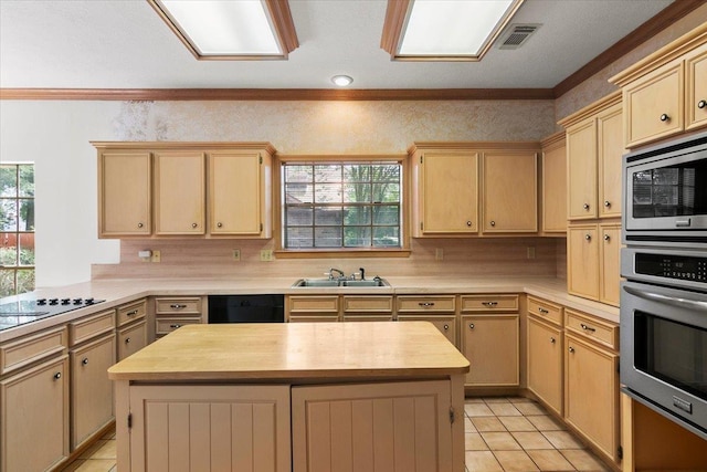 kitchen featuring wood counters, a kitchen island, black appliances, and sink