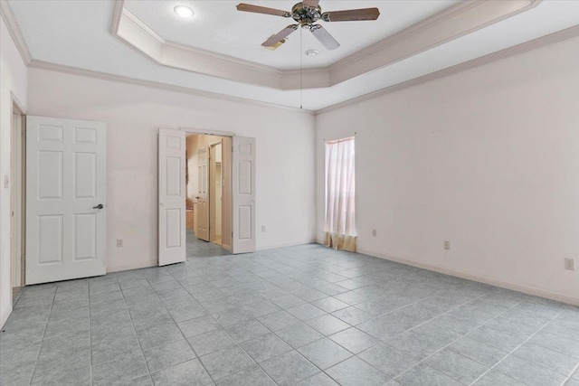 unfurnished bedroom with a tray ceiling, ceiling fan, light tile patterned floors, and ornamental molding