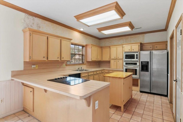 kitchen featuring a center island, ornamental molding, appliances with stainless steel finishes, a kitchen bar, and kitchen peninsula