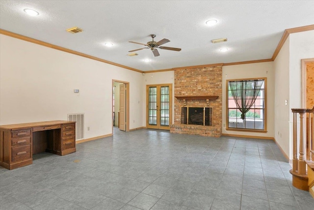 unfurnished living room featuring a brick fireplace, ceiling fan, a textured ceiling, and ornamental molding