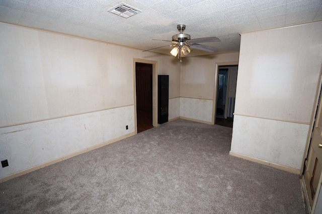 spare room featuring ceiling fan and carpet flooring