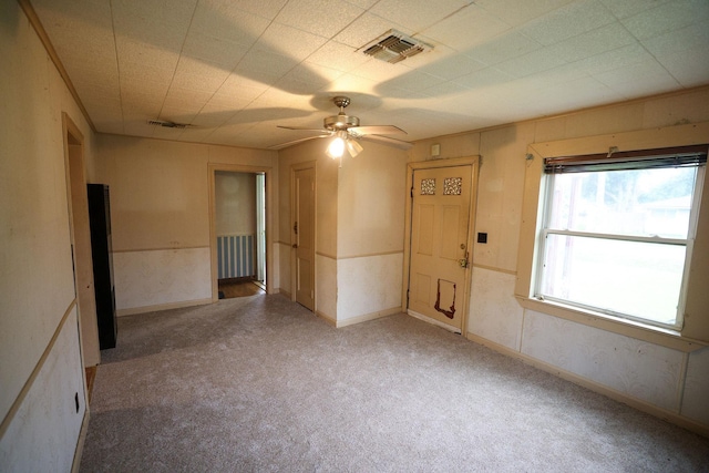 unfurnished room featuring ceiling fan and carpet flooring