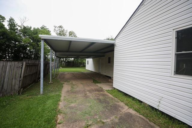 view of car parking featuring a carport and a lawn