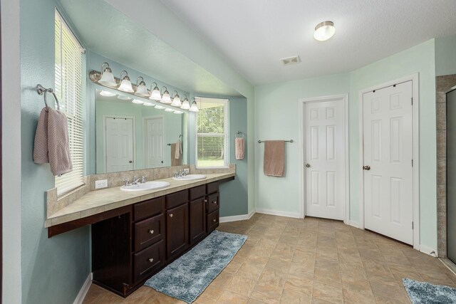 2360 County Road 2071, Hull, TX 77564 - bathroom featuring a sink, double vanity, baseboards, and visible vents
