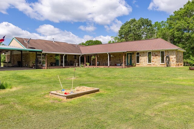 2360 County Road 2071, Hull, TX 77564 - view of front facade featuring a patio area, a carport, stone siding, and a front yard