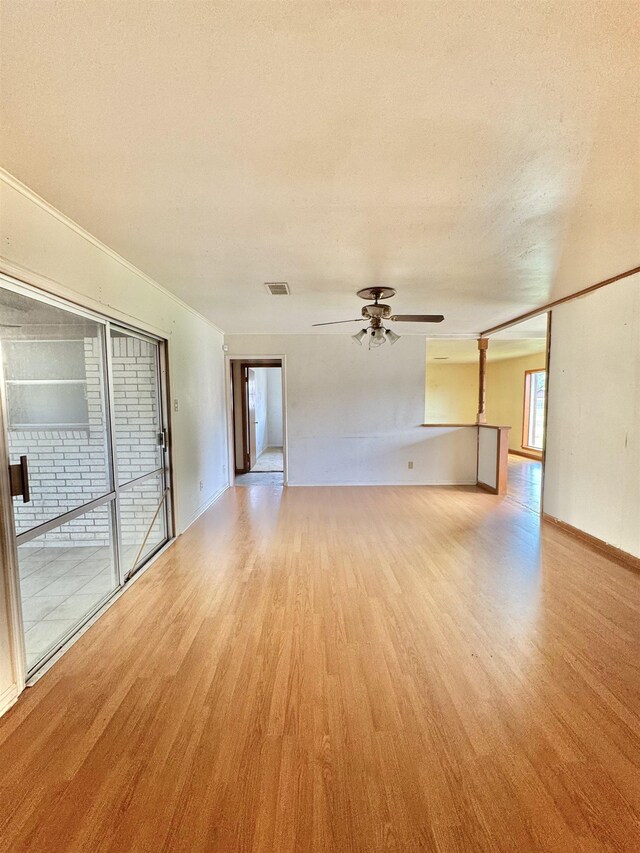 6219 16th St, Port Arthur, TX 77642 - empty room with a textured ceiling, light wood-type flooring, baseboards, visible vents, and ceiling fan