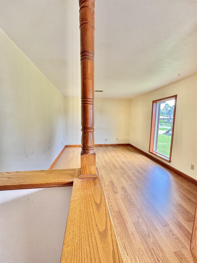 6219 16th St, Port Arthur, TX 77642 - unfurnished living room featuring baseboards and wood finished floors