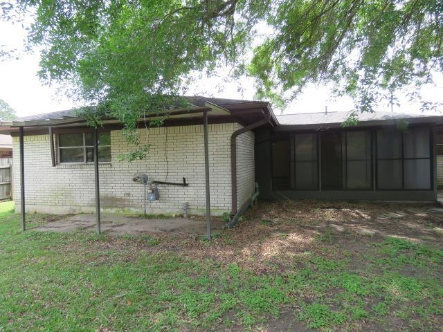6219 16th St, Port Arthur, TX 77642 - back of house with a sunroom and brick siding