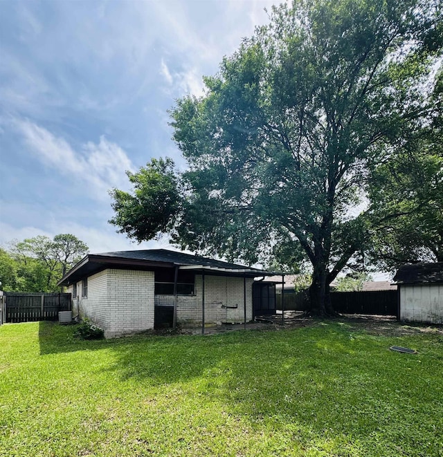 6219 16th St, Port Arthur, TX 77642 - view of yard featuring a fenced backyard and an outbuilding