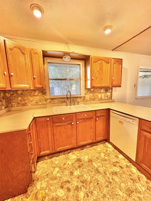 6219 16th St, Port Arthur, TX 77642 - kitchen with decorative backsplash, light countertops, dishwasher, a sink, and brown cabinetry