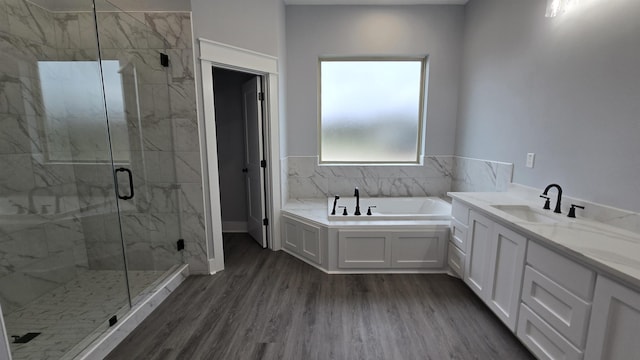 bathroom with hardwood / wood-style flooring, vanity, and independent shower and bath