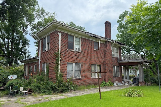 1010 Amarillo St, Beaumont, TX 77701 - view of side of property featuring a chimney, brick siding, and a yard