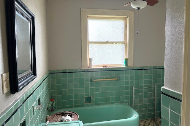 1010 Amarillo St, Beaumont, TX 77701 - bathroom with tile walls, wainscoting, and a bath