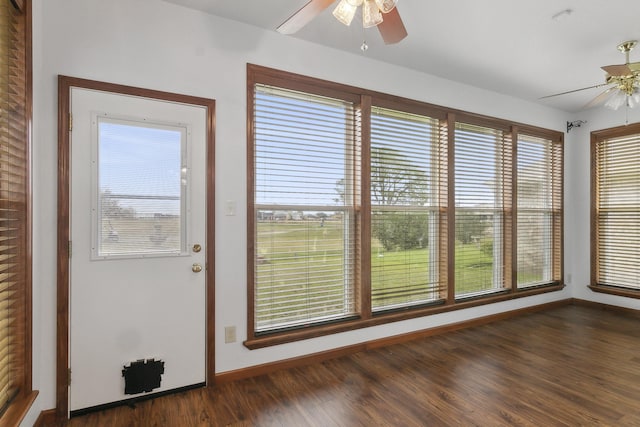 unfurnished sunroom featuring ceiling fan