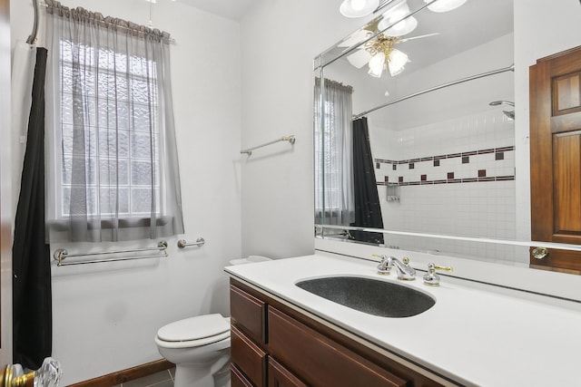 bathroom with a shower with curtain, tile patterned flooring, vanity, and toilet