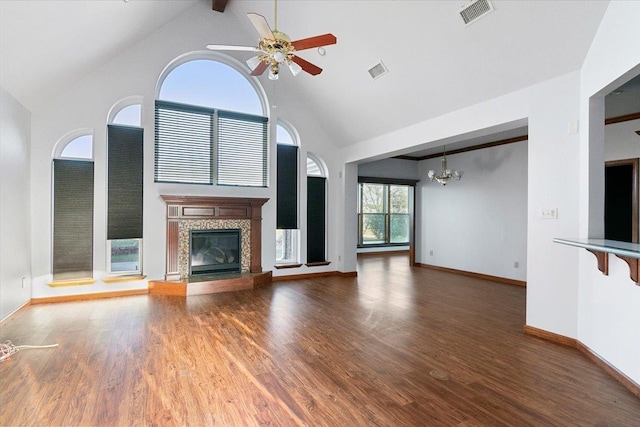 unfurnished living room with ceiling fan with notable chandelier, beam ceiling, wood-type flooring, and high vaulted ceiling