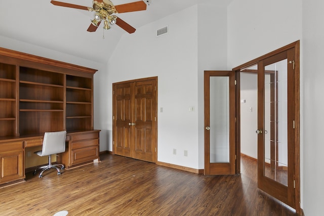 unfurnished office with dark wood-type flooring, high vaulted ceiling, french doors, ceiling fan, and built in desk