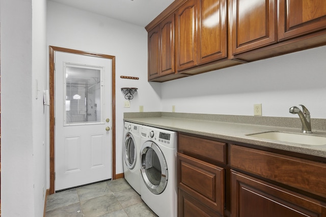 laundry area featuring cabinets, independent washer and dryer, and sink