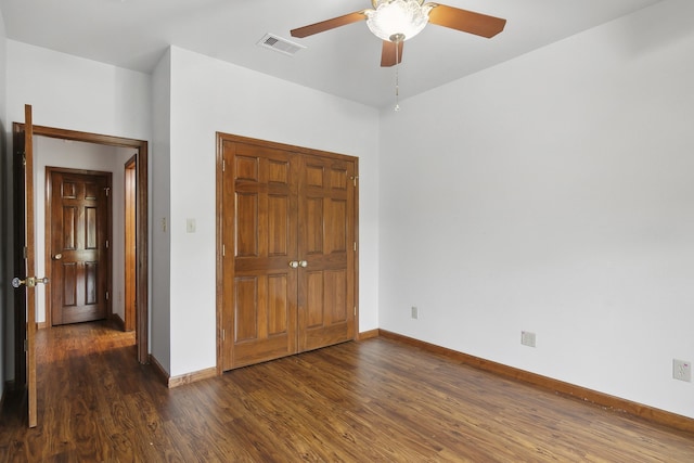 unfurnished bedroom with ceiling fan and dark hardwood / wood-style flooring