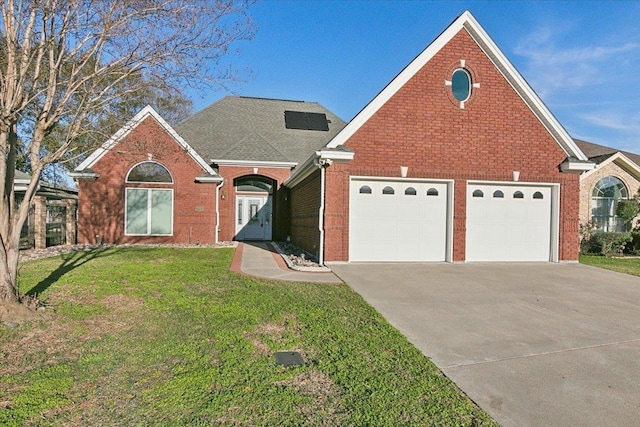 view of front of home with a garage and a front yard