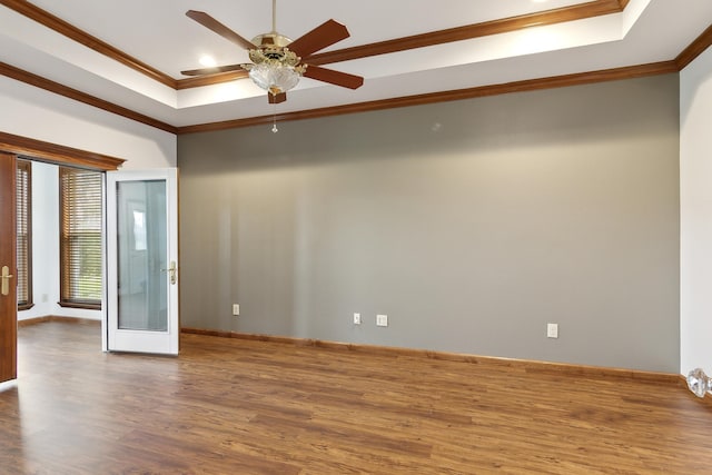 spare room featuring ceiling fan, french doors, a raised ceiling, crown molding, and hardwood / wood-style floors