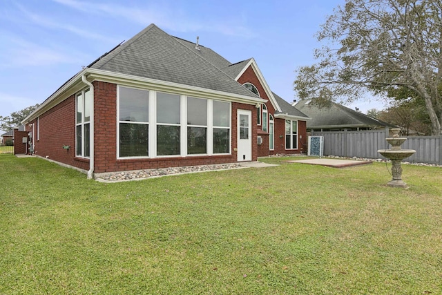 back of property with a patio area and a lawn