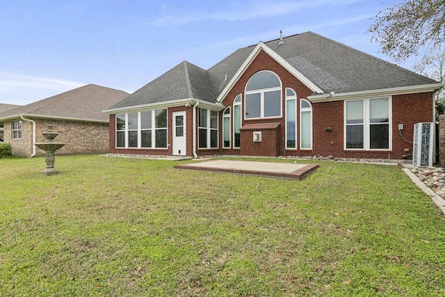 rear view of house with a yard and a patio